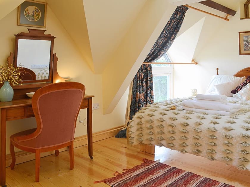 The wood floor and traditional dressing table make the double bedrom sophisticated and chic | Yr Wyddfa - The Old School, Caeathro, Caernarfon