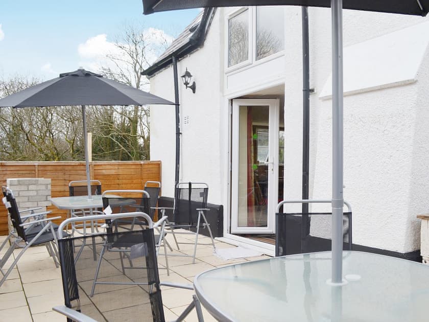 A brick built barbecue and plenty of seating make the patio an ideal place for entertaining outdoors | Yr Wyddfa - The Old School, Caeathro, Caernarfon