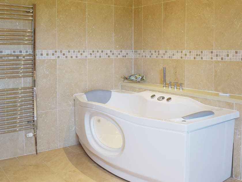 There is a Jacuzzi bath and heated towel rail in the bathroom | Tan Y Castell, Llanmill, near Narberth