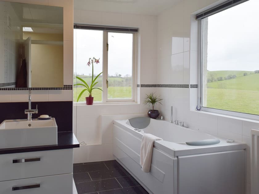 The second bathroom also has a Jacuzzi bath and has windows on two aspects giving great views over the countryside | Tan Y Castell, Llanmill, near Narberth
