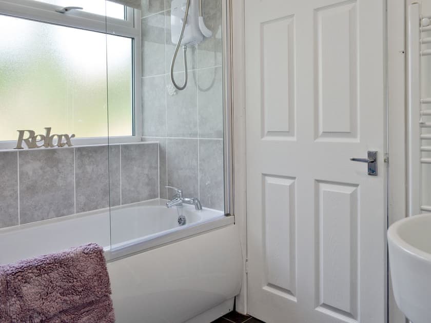 Family bathroom with shower above bath | Penteryfn, near Holyhead, Isle of Anglesey