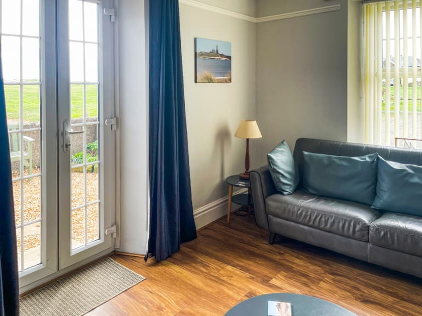 The light and airy living room has access via French doors to the private courtyard | Island View, Amble