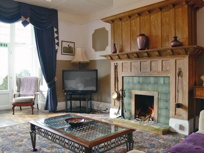 Cosy living room with open fire | Beaford House, Beaford, near Winkleigh