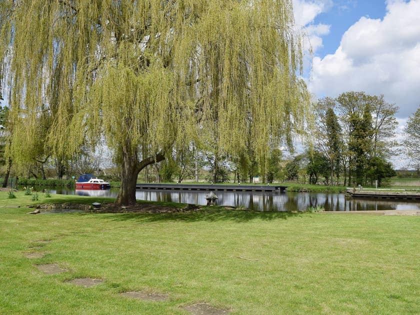 The River Nene flows past at the foot of the shared garden | River Nene Cottages, Water Newton, near Peterborough