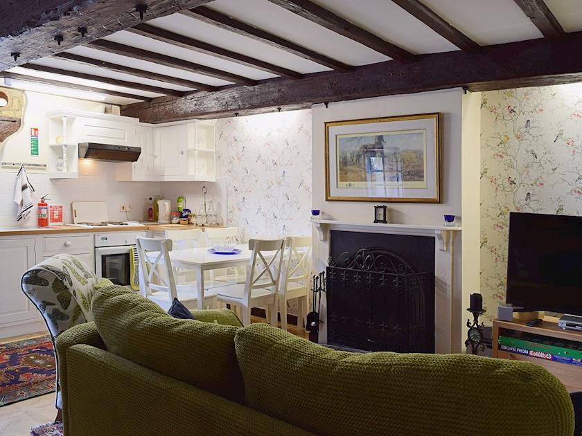 The quaint open plan living area with open fireplace | Yew Tree Cottage - River Nene Cottages, Water Newton, near Peterborough