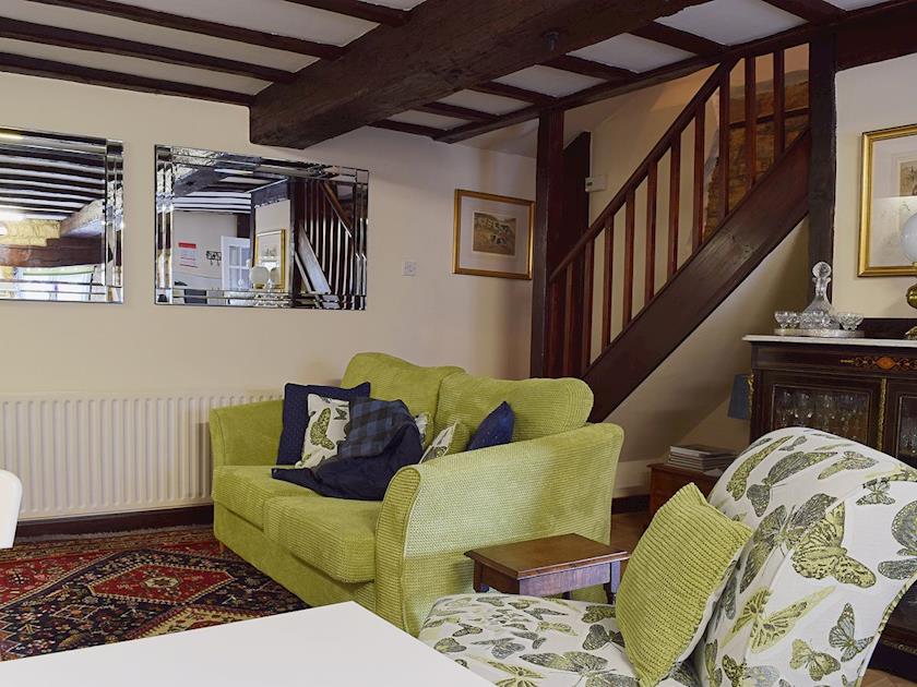 The beamed ceiling complements the exposed woodwork of the staircase | Yew Tree Cottage - River Nene Cottages, Water Newton, near Peterborough