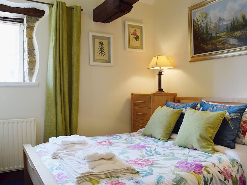 There is a king sized bed in the double bedroom | Yew Tree Cottage - River Nene Cottages, Water Newton, near Peterborough