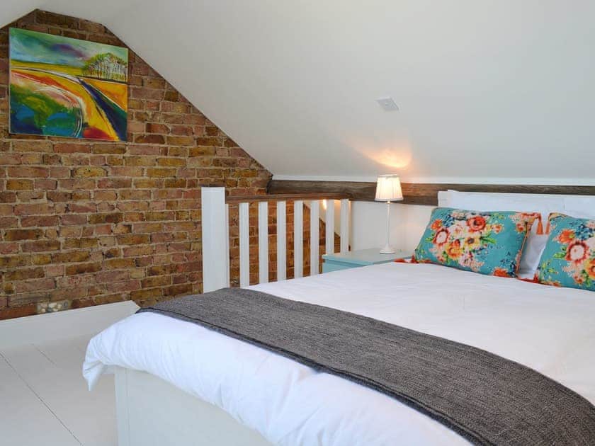 Exposed brickwork and smart decor in the double bedroom | Coastguard Cottage, Swalecliffe, near Whitstable