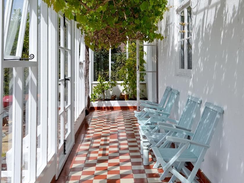 Shaded seating in the conservatory | Yawl House, Uplyme, near Lyme Regis