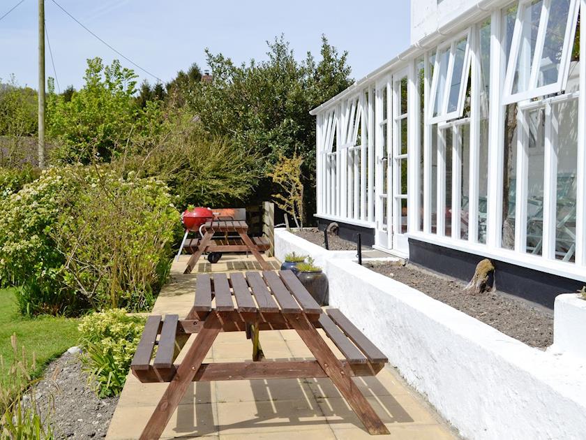 Paved patio/terrace with BBQ area and ‘picnic style’ outdoor furniture | Yawl House, Uplyme, near Lyme Regis