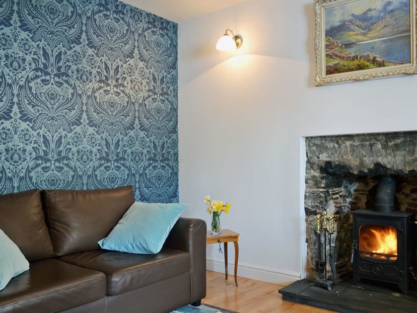 Homely living room with cosy multi-fuel burner | Loch Shore Cottage, Dornie, near Kyle