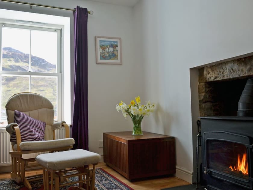 Homely living room with cosy multi-fuel burner | Loch Shore Cottage, Dornie, near Kyle