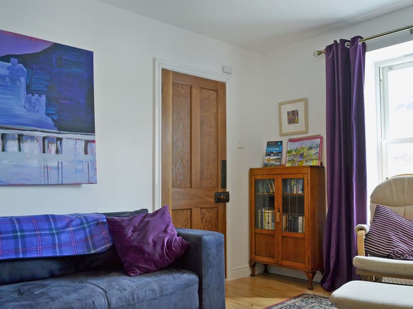 Homely living room with cosy multi-fuel burner | Loch Shore Cottage, Dornie, near Kyle