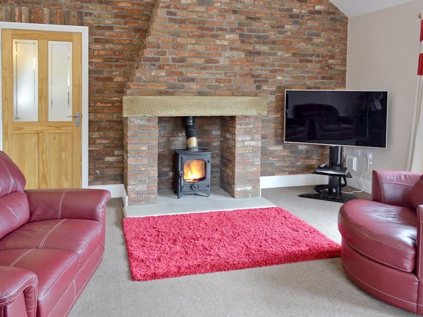 Stylish living room with wood burner | Bumblebee Cottage - Honeybee Holiday Homes, Skipsea, near Hornsea