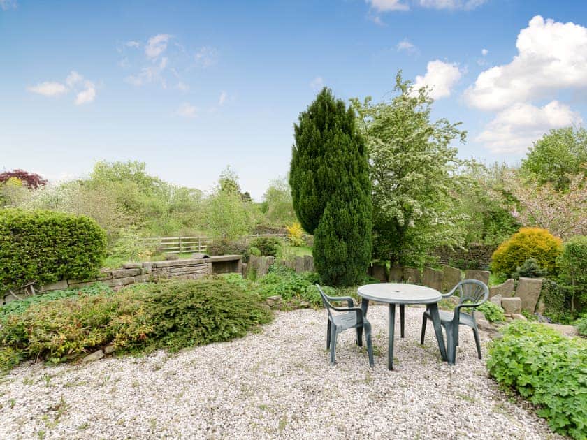 Outdoor seating area and garden | Brookside Cottage, Beeley, near Chatsworth