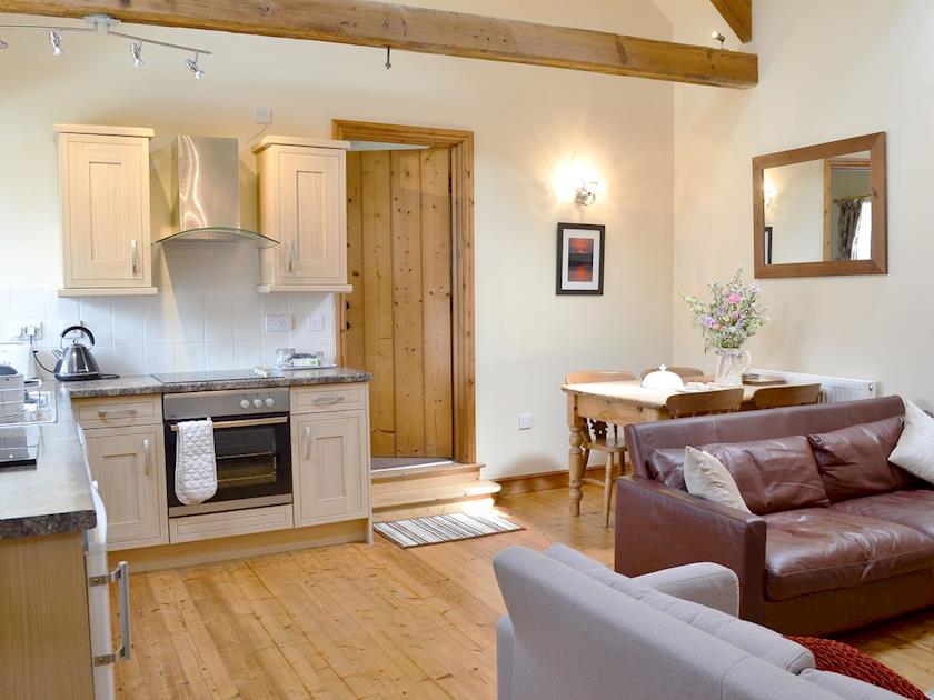 High ceilings, with beams give character to  this open plan style living/ kitchen/ diner | Guillemot Cottage - Manor Farm Cottages, Buckton, near Flamborough