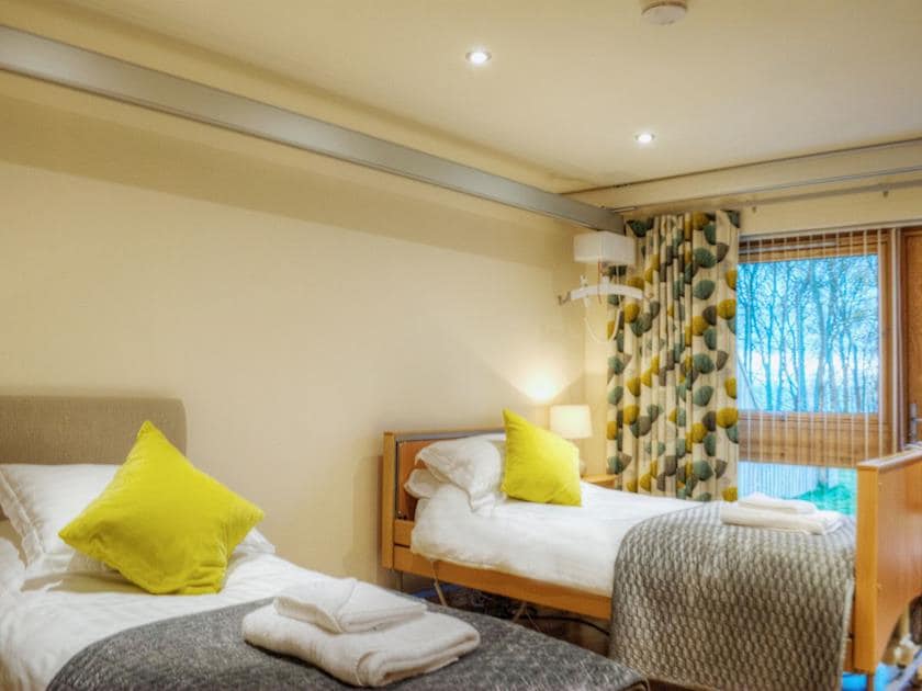 The cosy ground floor twin bedroom is fitted with a hoist and special bed making it accessible for all | HomelandsDrummochy, Lundin Links near Anstruther