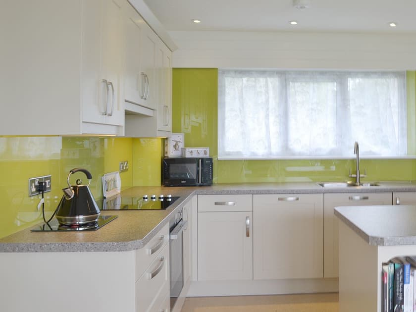A contemporary style kitchen has a centre island and wine chiller  | Tamar Ten, St Ann’s Chapel, near Callington