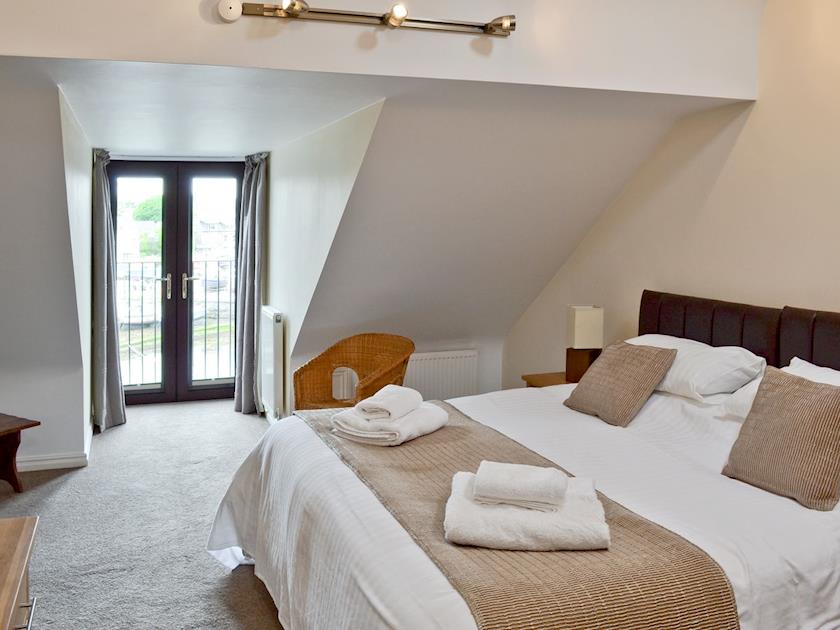 Master bedroom with ‘Juliet’ balcony | Harbour View, Castletown