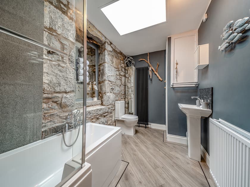 Stylish bathroom with exposed stone feature wall | Creebank, Newton Stewart