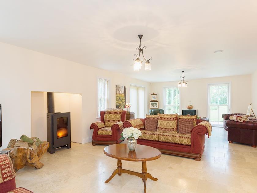 Tile-floored living room with wood burner | Yokefleet Cottage, Sandholme, near Beverley