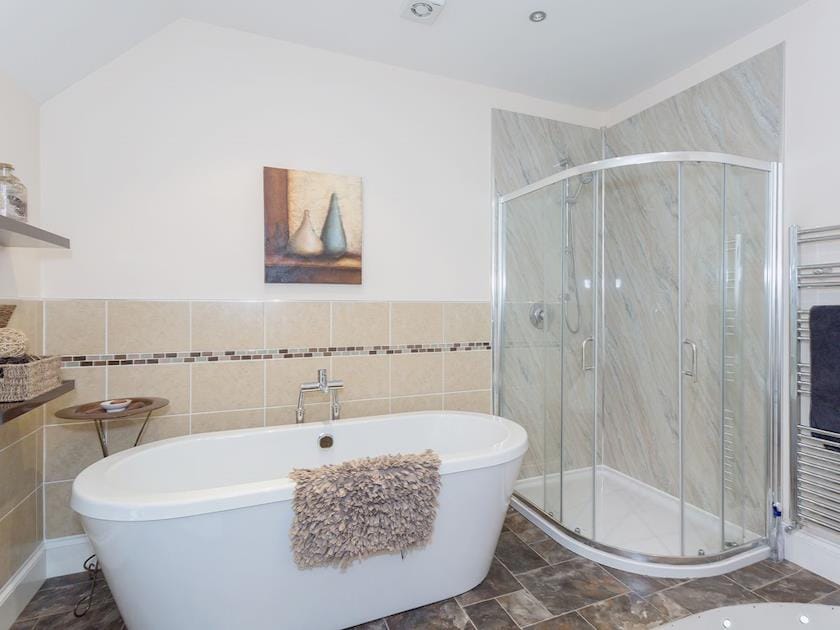 Bathroom with double shower and standalone bath | Yokefleet Cottage, Sandholme, near Beverley