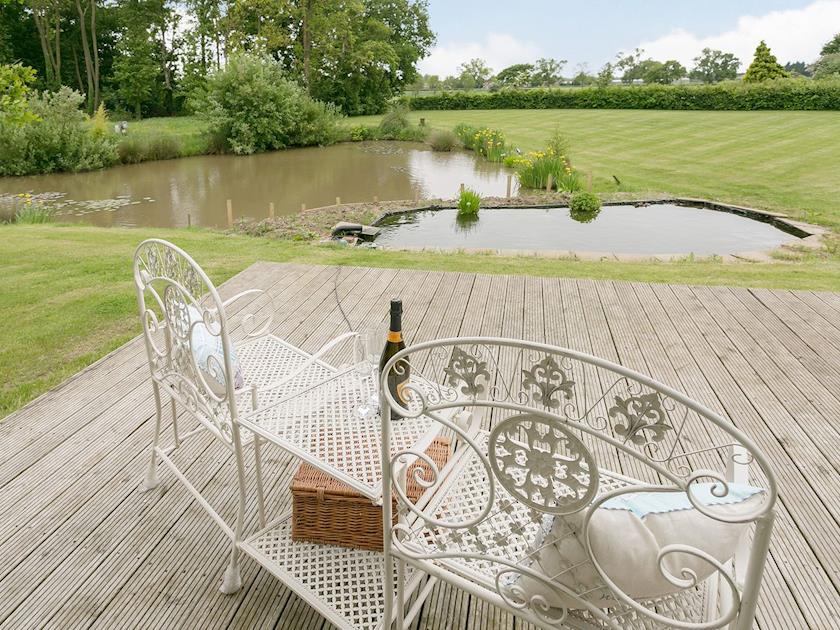 The garden room has a large decked area from which to enjoy the garden and grounds | Yokefleet Cottage, Sandholme, near Beverley