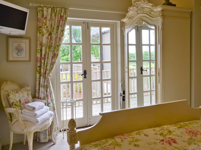 Double bedroom with French doors to terrace | The Pavilion, Killerby, near Scarborough