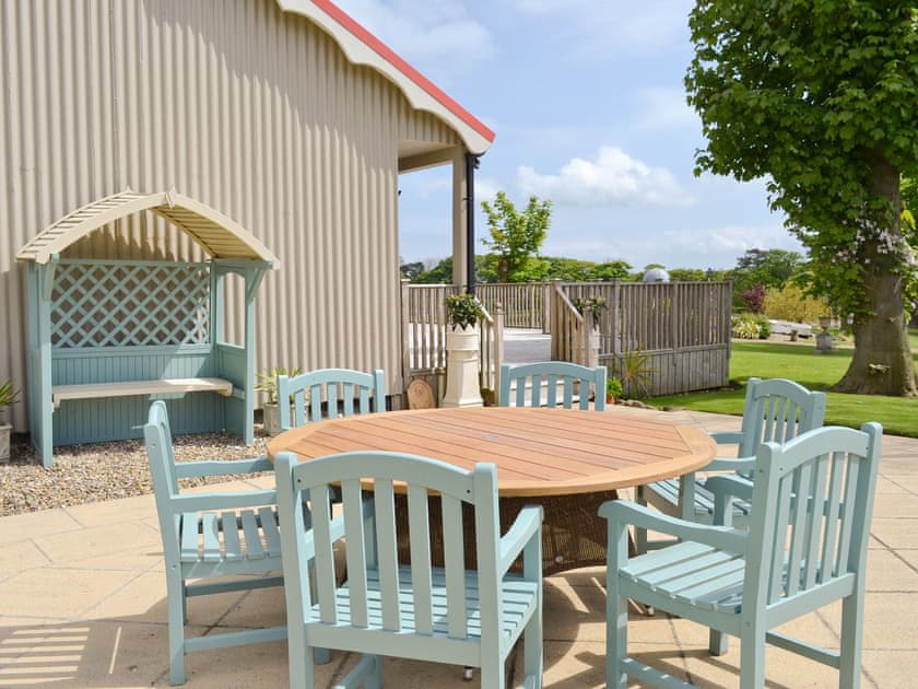 Extra outdoor seating on paved patio at side of property | The Pavilion, Killerby, near Scarborough