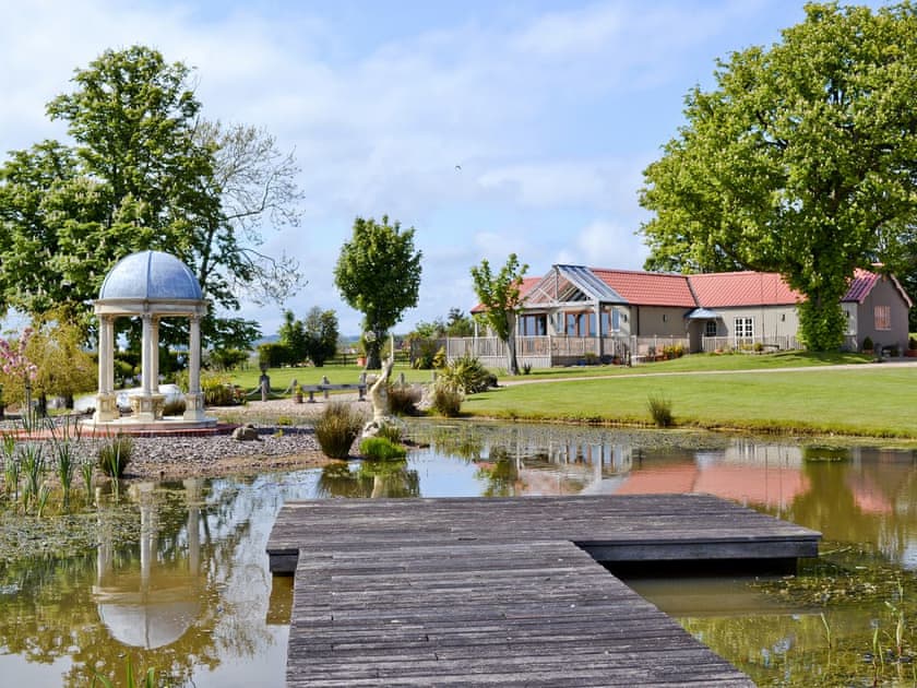 View over the lake to the property | The Pavilion, Killerby, near Scarborough