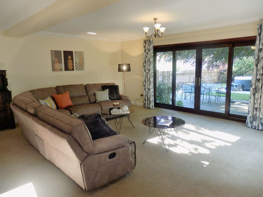 Spacious living room with patio doors to garden | The Beech House, Corton, near Lowestoft