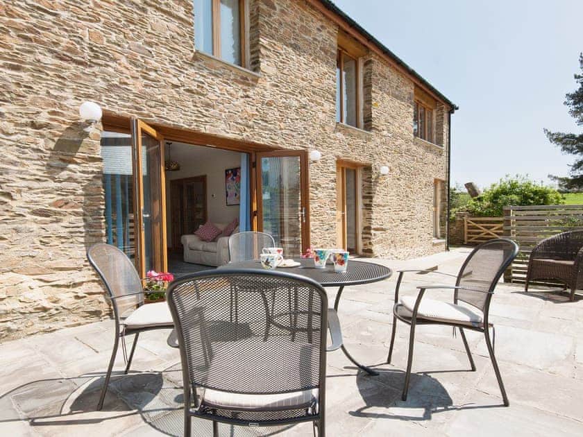 The outdoor sitting area outside the kitchen diner is a great spot to catch the sun | Blackdown Farm, Manor Barn, Blackawton, nr. Dartmouth