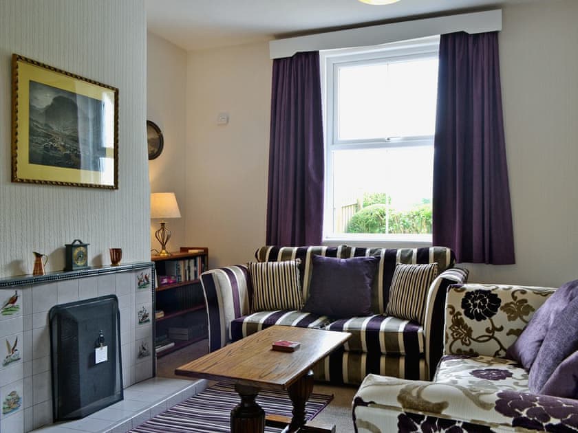 Homely living room with open fire | Howe Bridge House, near Portinscale
