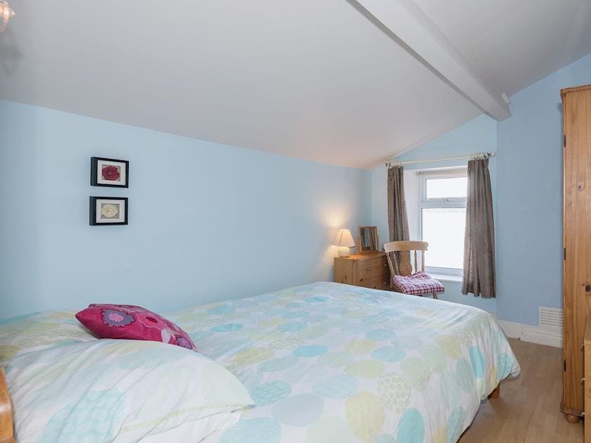 Bedroom with sloping ceiling and double bed | Lazy Cottage, Haverigg, near Millom