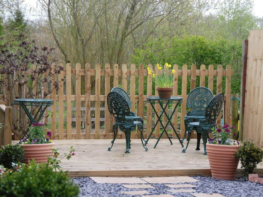 Decked sitting-out-area in garden  | Fir Tree Cottage, Stretton-on-Fosse, near Moreton-in-Marsh
