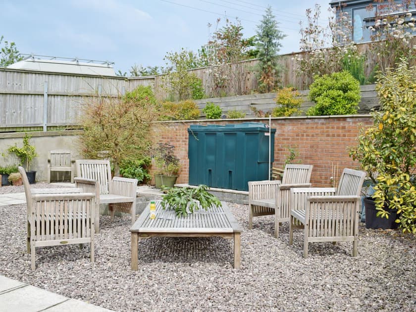Enclosed patio with garden furniture and BBQ | Ty Cornel, Aberporth, near Cardigan