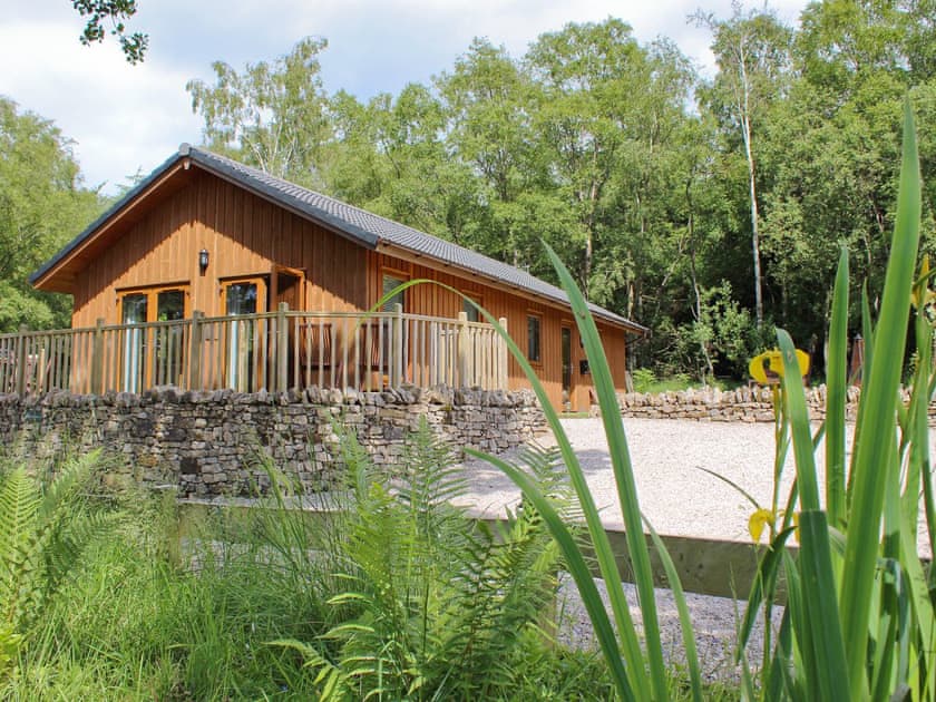 The cabin is set amongst the extensive part-wooded grounds | Rowanburn Lodge, Greystoke, near Penrith