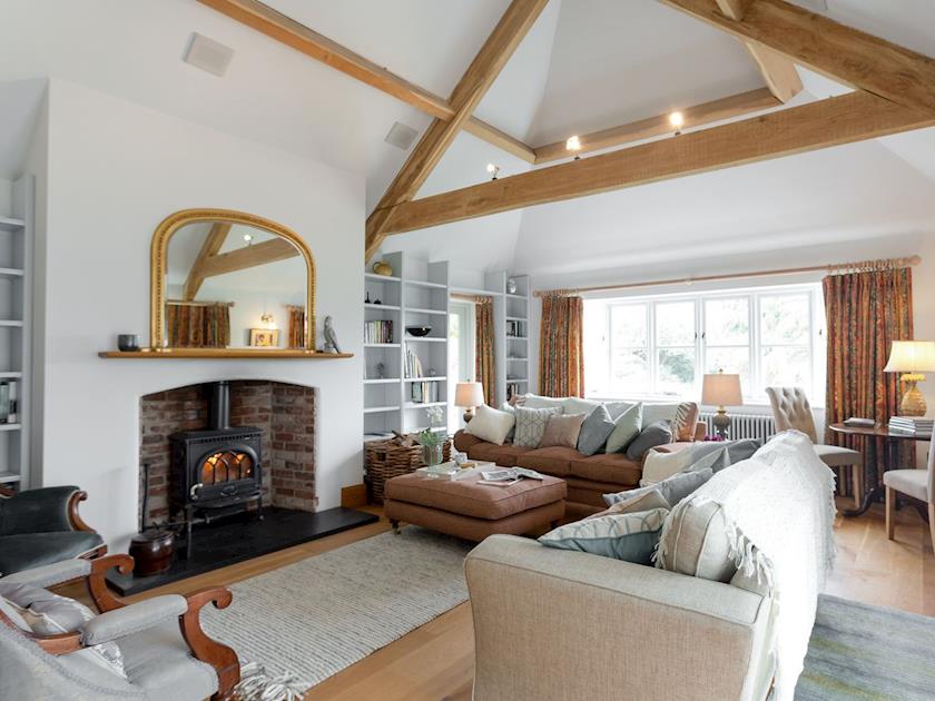 Grand living room with beamed ceiling and woodburner | The Old Coach House, Colyton, near Honiton