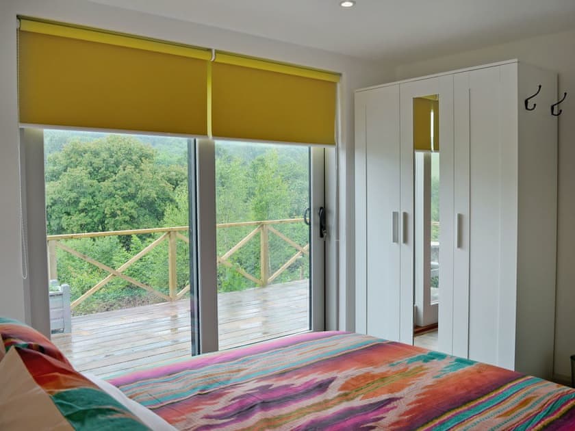 Comfortable double bedroom with doors leading to patio  | The Shed with a View, Cadbury, near Crediton