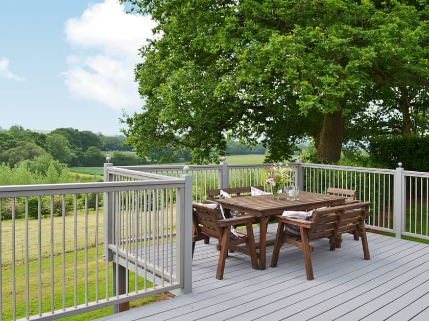 The decking is a great place for an outdoor meal | Wattles - Lawpit Lodges, Uplowman, near Tiverton