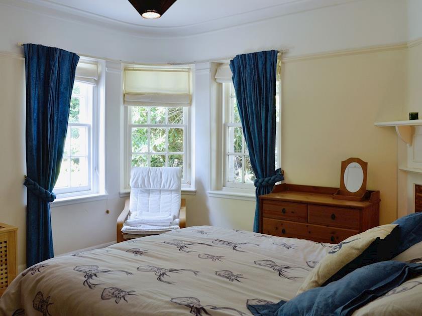 Lovely double bedroom with decorative fireplace | Dunlappie Lodge, Edzell, near Brechin