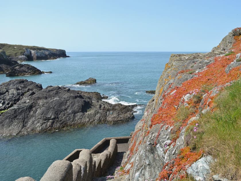 Stone step access to a private beach | Bwthyn Y Borth, Rhoscolyn, near Holyhead