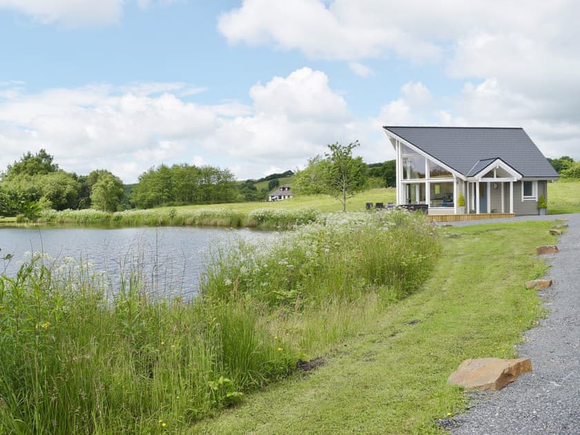 Stunning timber lodge on the edge of a private lake | Heron Lodge, Five Roads, near Llanelli