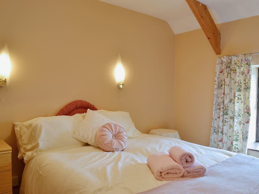 Romantic double bedroom with exposed woodwork | Ty Coch Cottage, Near Aberaeron