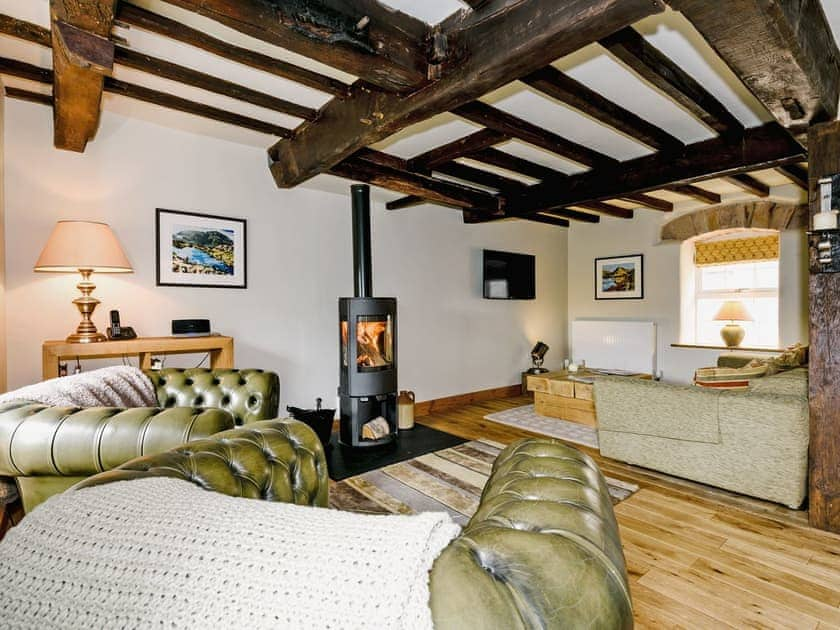 Warm and spacious living area with woodburner and river views | The Old Mill, Great Strickland near Penrith