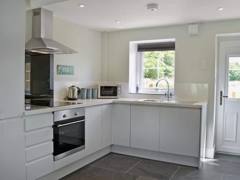 Well equipped galley-style kitchen/dining room | Bird Song Cottage - Vaynor Fach Cottages, Clynderwen, near Narberth