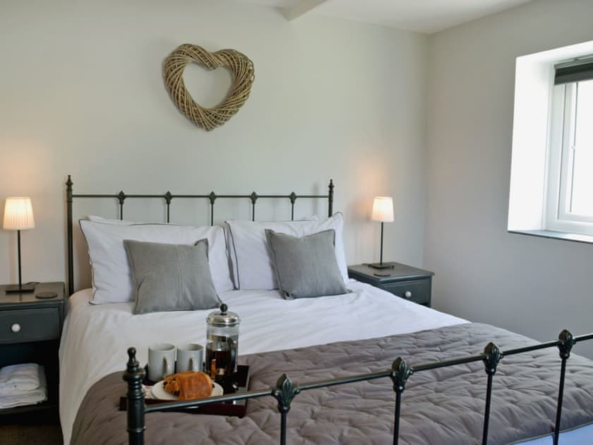 Comfortable double bedroom with kingsize bed and beams | Bird Song Cottage - Vaynor Fach Cottages, Clynderwen, near Narberth