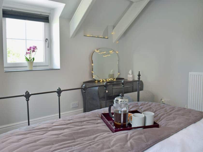 Comfortable double bedroom with kingsize bed and beams | Bird Song Cottage - Vaynor Fach Cottages, Clynderwen, near Narberth