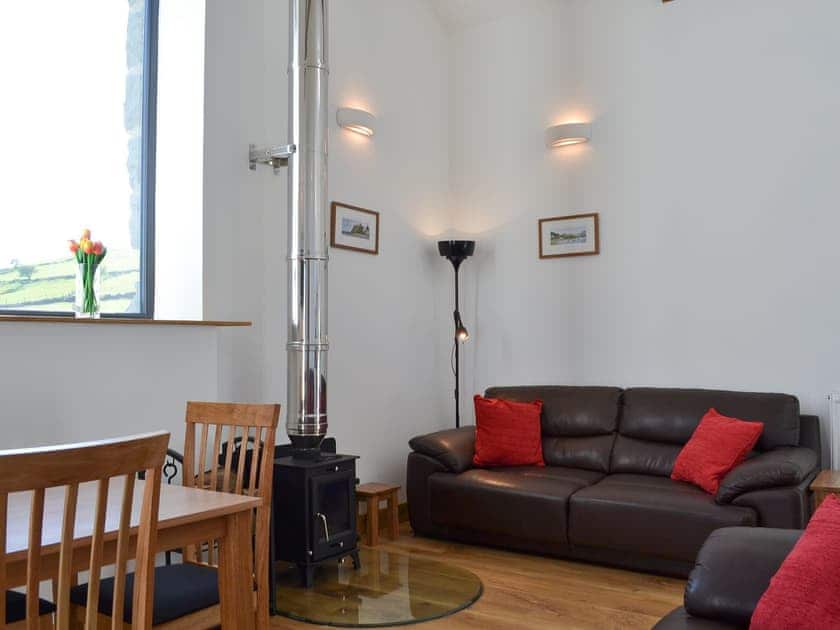 Open plan style living space with wood burner | The Granary - Tyddyn Iolyn, near Criccieth