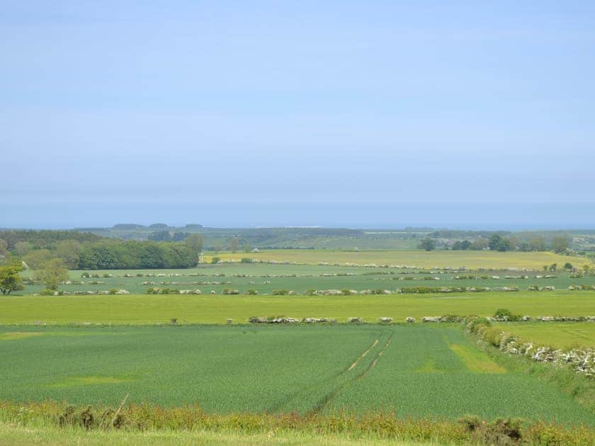 There is a fine view across the rolling countryside to the North Sea coast | Etive Cottage, Warenford, near Belford